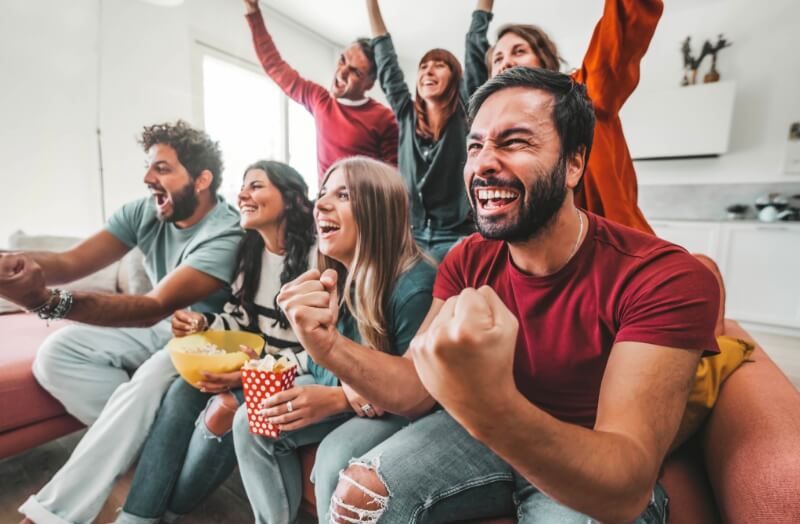 A group of friends watching sports on tv